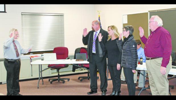 Pulaski Circuit Court Judge Michael Shurn swore in school board members Deke DeMarco, Terri Johnston, Beth Ruff and Larry Beach before the regular school board meeting Monday evening. DeMarco, Johnston and Beach are all returning school board members.
