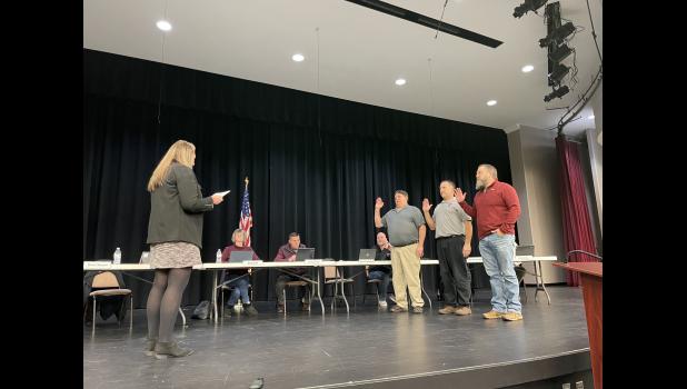 Photo by Megan Galbreath Corporation treasurer Stefanie Grandstaff conducted the swearing-in ceremony for school board members Joe Cunningham, Tim Rausch and Aaron Campbell during a regular board meeting on Jan. 9.