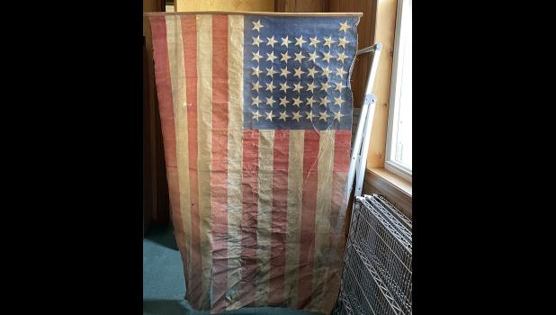 Photo by Megan Galbreath An American flag dating back to the 1890s was found in the county clerk’s vault during the deconstruction of book storage shelving.