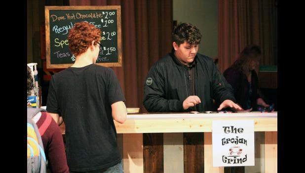 During the grand opening of the Trojan Grind coffee bar, West Central sophomore Robert Woodward keeps busy taking orders.