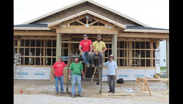 Workers took a break and posed for a picture in front of the future LifeWise Academy West Central building. Pictured are Aaron Malchow, Jonathan Good, Brian Putt, Noah Young (top), Ryan Smith and Steffan Parry.