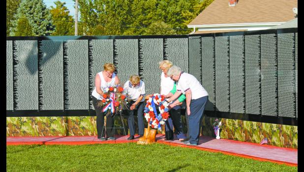 Ladies of the American Legion Auxiliary placed wreaths at the Vietnam Traveling Memorial Wall that was assembled in Francesville during the fall festival last weekend, in remembrance and honor of those who served.