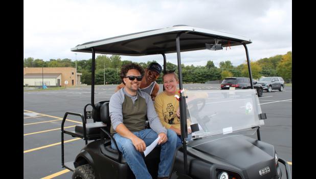 Photos by Megan Galbreath Kyle Sefchek, Brandy Goble and Mike Haschel celebrated a win at the end of the run when they won best decorated cart. The team donned their cart with red poppies.