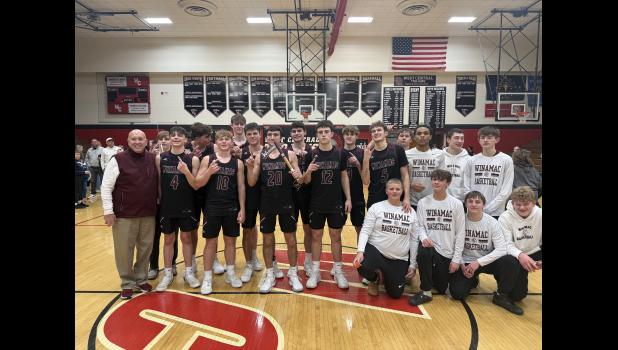 Photo by Paul Hettinger The Winamac Warriors celebrate an overtime victory over the West Central Trojans and bring the Tomahawk Trophy back home.