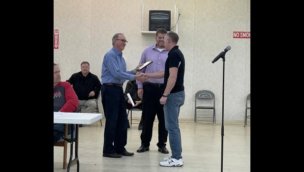 Photo by Megan Galbreath Pulaski County EMS Director Brandon DeLorenzo received a certificate for his 10 years of service from Commissioner president Chuck Mellon and council vice president Adam Loehmer.