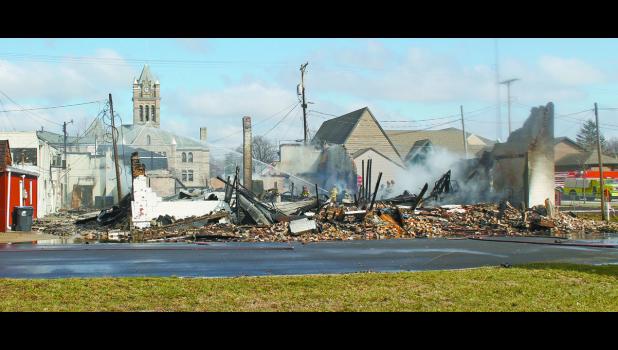 More than a year and a half after a fire that destroyed two buildings, the rubble has yet to be removed from one of the lots.