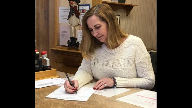 Lynn Wilder, who is acting as interim county clerk, led JoLynn Behny Johnston in the oath of office on Dec. 19, a day after she was appointed to the position during a Republican caucus.