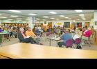 Numerous teachers, former students and community members who were concerned about the future of teacher and varsity basketball coach Kyle Johnson gathered in the Winamac Community Middle and High School Library during a regular school board meeting Monday evening.