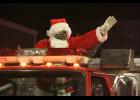 Escorted to town by the Winamac Fire Department, Santa waves to everyone along the parade route.