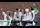 Makayla Dulin, Victoria Wildermuth, Taylor Jennings and Shailyn Day wave to well-wishers as they leave the school grounds after graduation for a parade through Winamac. 