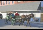 Photo by Megan Galbreath Families enjoyed a quick trip around downtown Francesville in an old fashioned carriage.