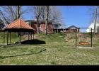 Photo by Megan Galbreath A pollinator garden is proposed to go behind the Darda family bench and around the artesian well on the west side of the Winamac Town Park.