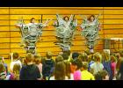 To the delight of EPES students Susie Schultz, Jill Collins and Maureen Garrity hang suspended from the gymnasium bleachers.