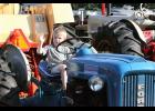 Three-year old Zander Smith tries a Ford tractor on for size.