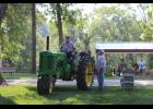 Tractor Fest attendees enjoy swapping stories as they admire the many John Deere tractors on display at P.J. Gilsinger’s 5th annual Tractor Fest on Saturday, Aug. 3.