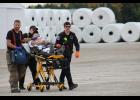 The “shooter” is wheeled to the ambulance for treatment of a chest wound.