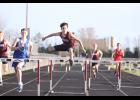 Clearing another hurdle, Winamac’s Dylan Guilford is on his way to a first-place finish.