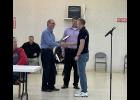 Photo by Megan Galbreath Pulaski County EMS Director Brandon DeLorenzo received a certificate for his 10 years of service from Commissioner president Chuck Mellon and council vice president Adam Loehmer.